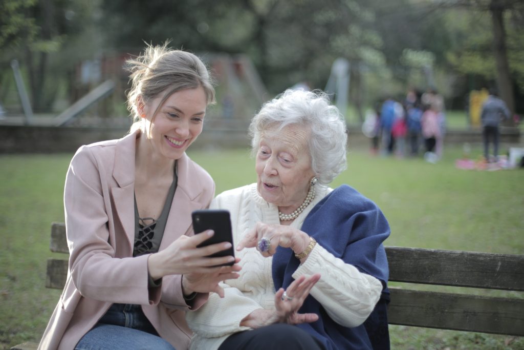Woman helping elderly lady