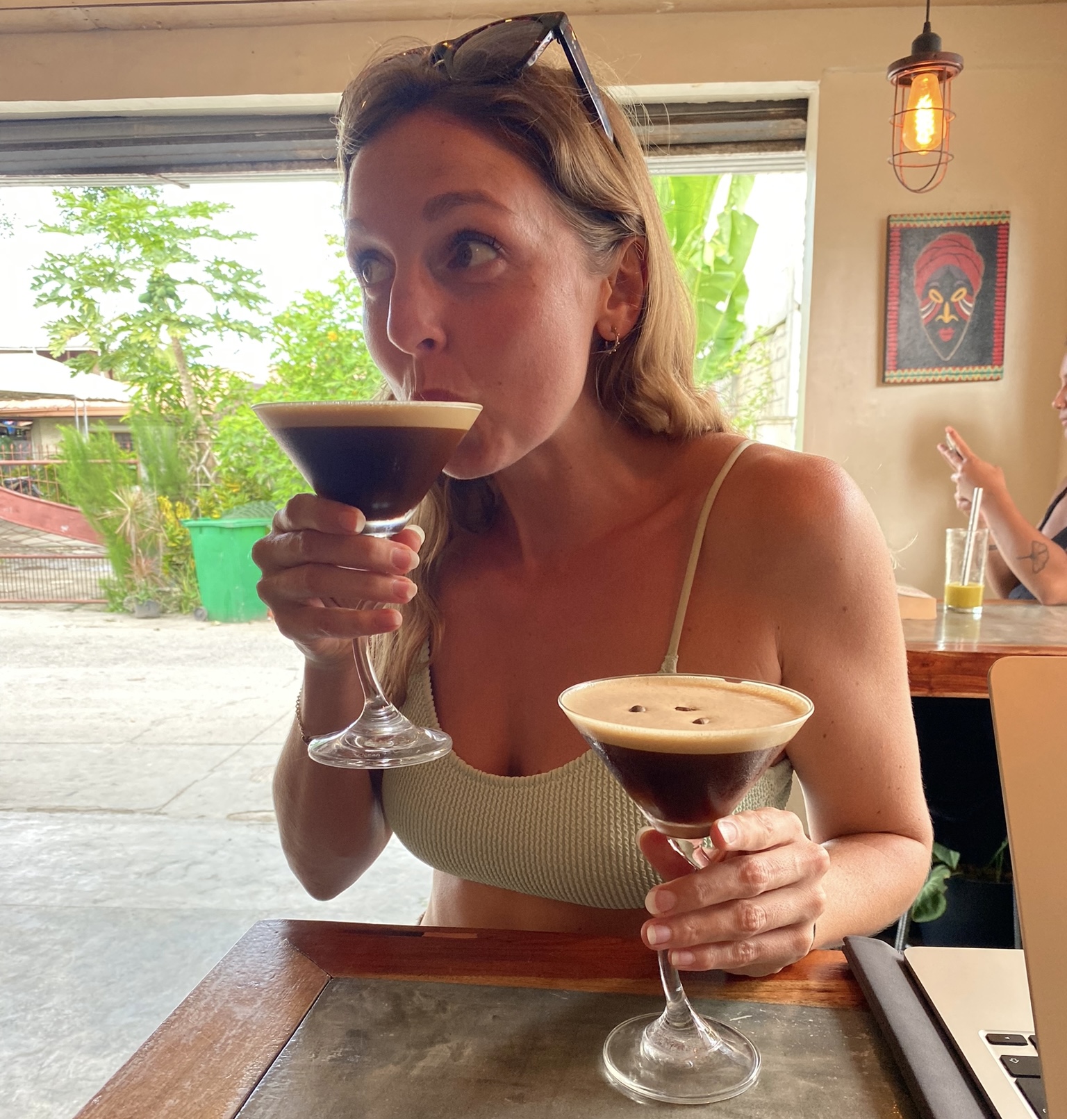 Single woman drinking two cocktails