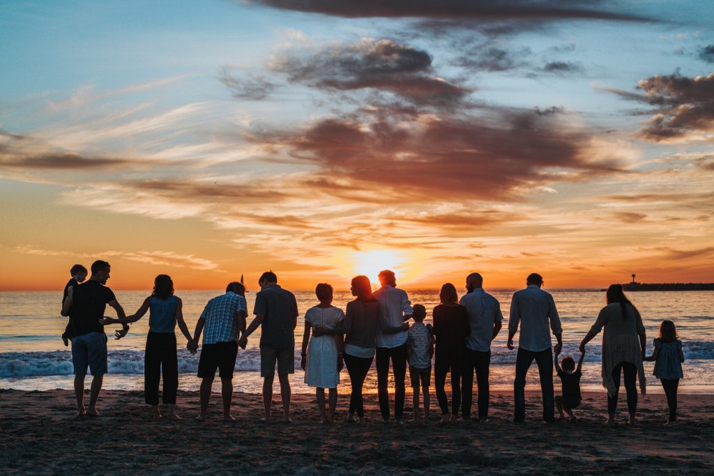 Friends on a beach at sunset