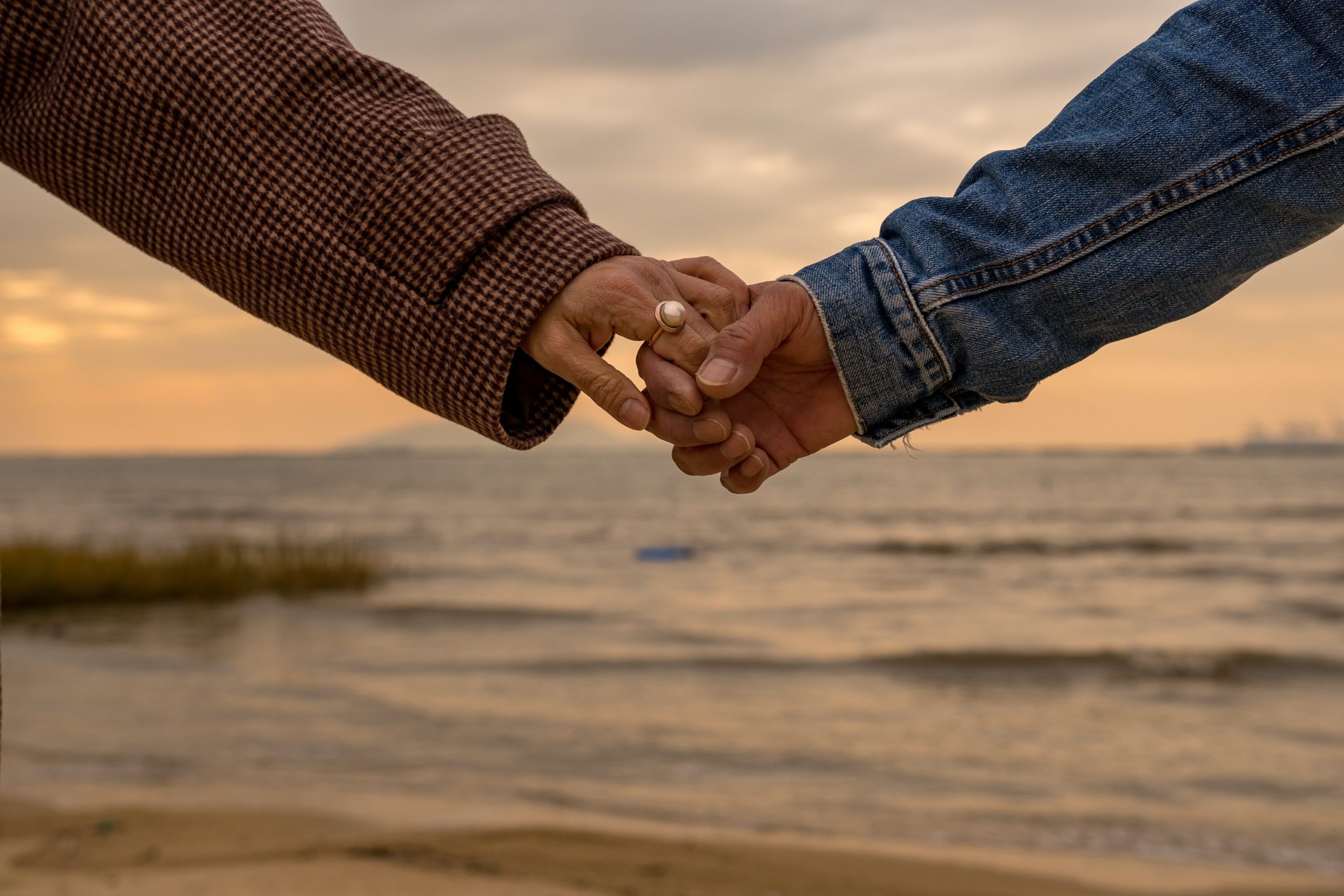 A couple holding hands at the beach