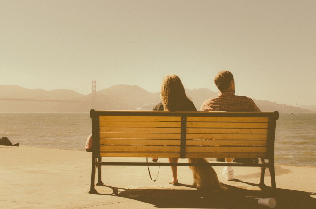 jealous couple sat on a bench