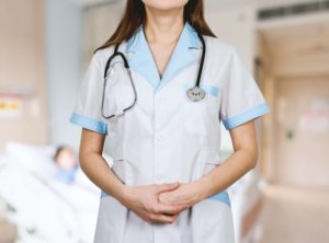 Nurse standing with her hands together