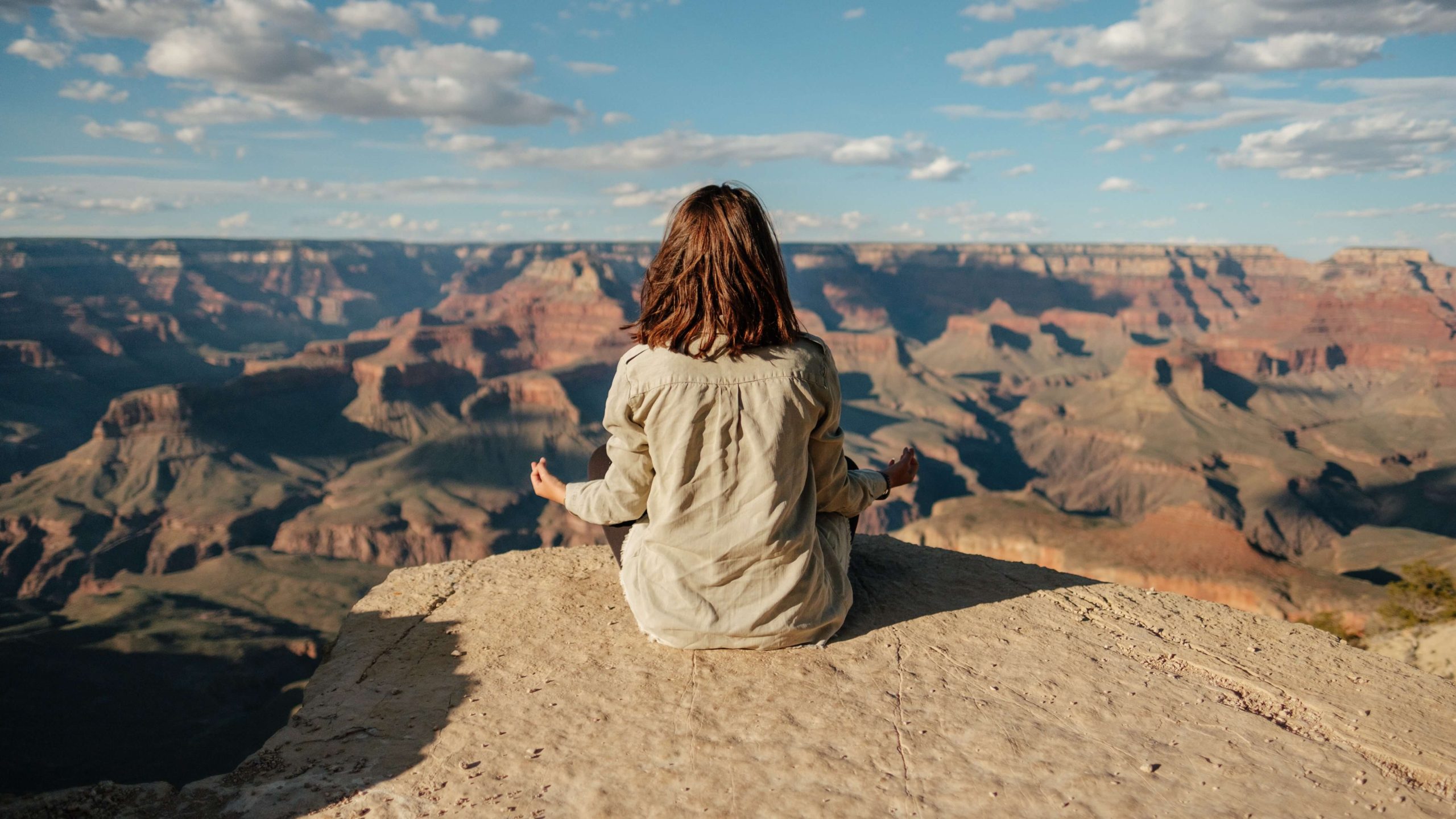 woman sat on a hill meditating
