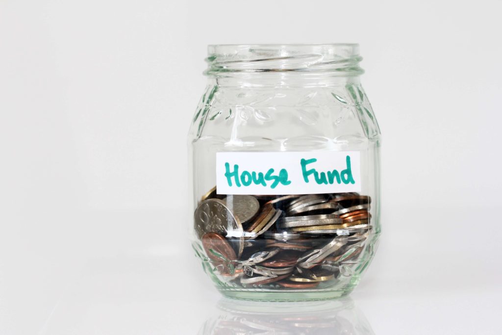 A money jar with the label 'House funds' on it