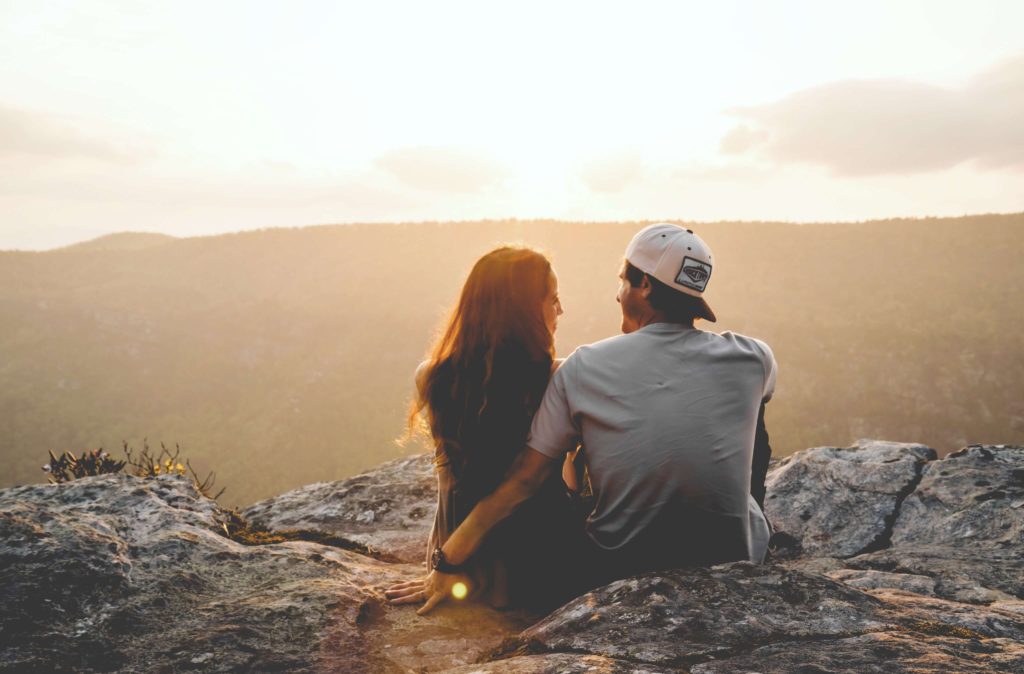 Couple looking at view with arms around each other