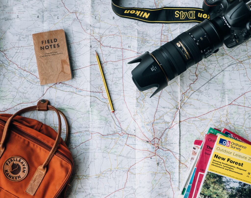 A map, camera, bag, pencil and note pad