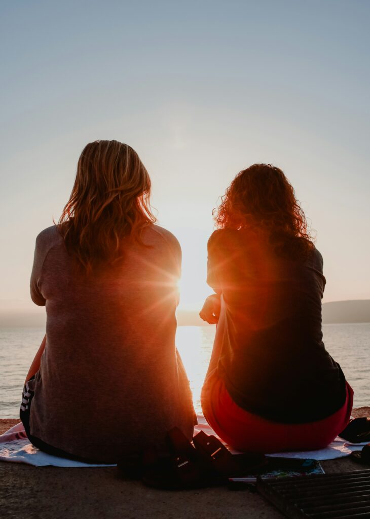 Friends sitting by the water