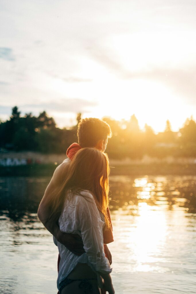 Couple walking by a river talking