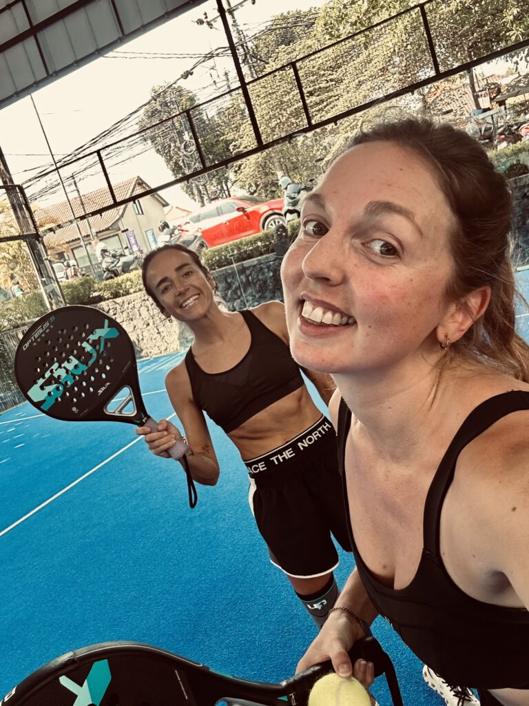 Women having fun playing padel