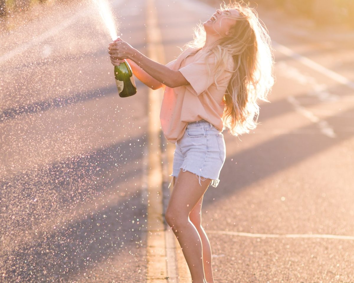 Girl standing in the road with champagne